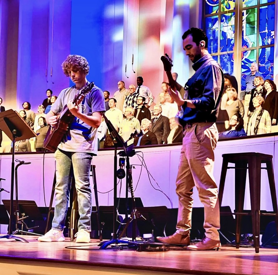 Sebastian Gomez guitar instructor headshot with an acoustic guitar, ready to teach online lessons